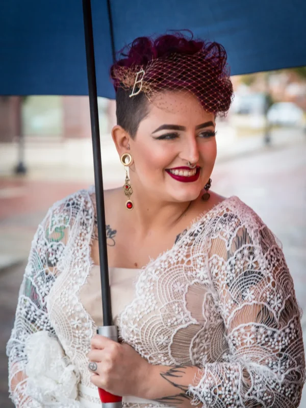 smiling-woman-costume-holding-blue-umbrella-event