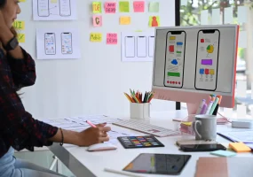 young-female-website-designer-working-studio-create-application-mobile-phone