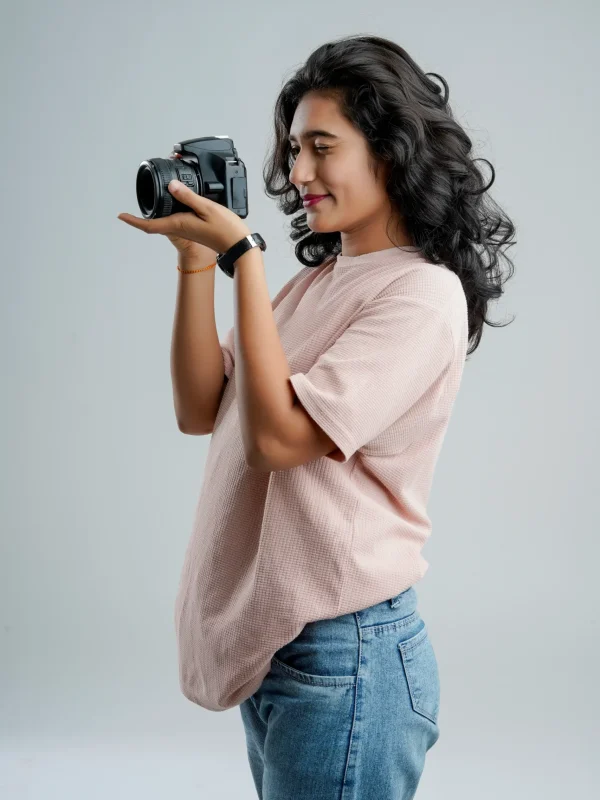 young-woman-with-professional-camera-isolated-background